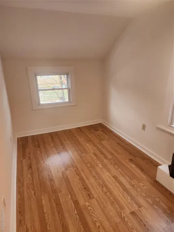 a view of a room with wooden floor and windows