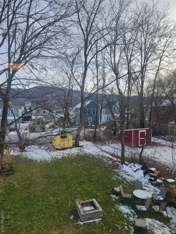 a view of a backyard with swimming pool