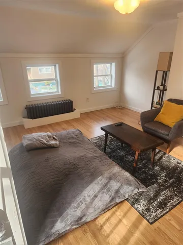 a bed sitting in a bedroom next to a window
