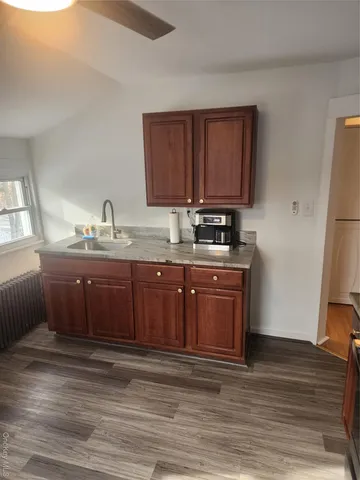 a kitchen with a sink a stove and cabinets