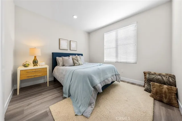a bedroom with a bed and wooden floor