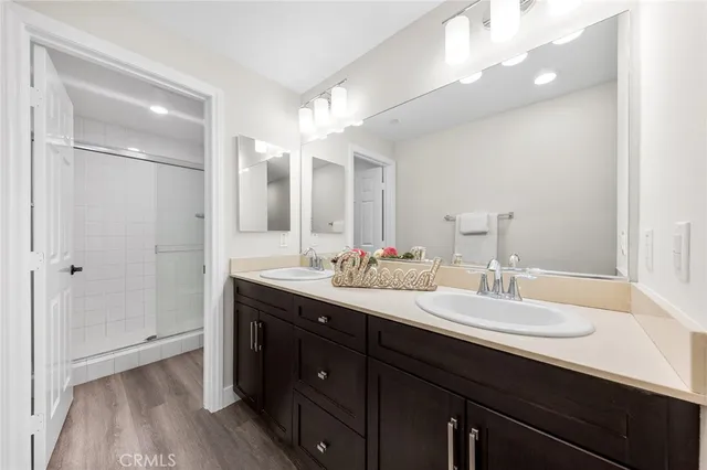 a bathroom with a double vanity sink and mirror