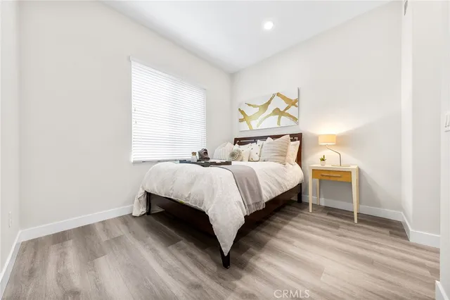 a bedroom with a bed and a night stand