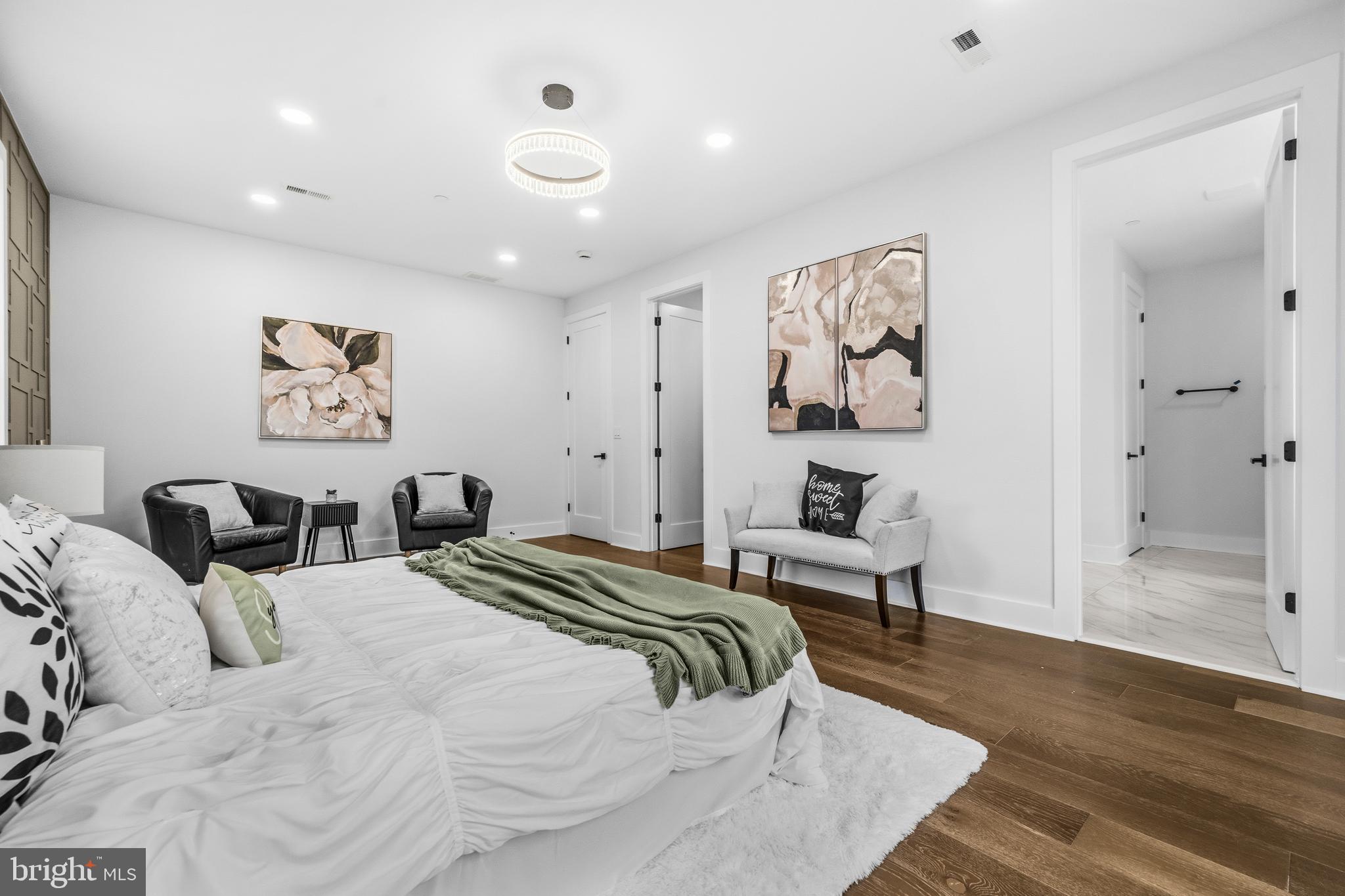 414 Waterford Road Silver Spring, MD 20901 - Photo 22 of 67 a bedroom with a large bed and a chandelier