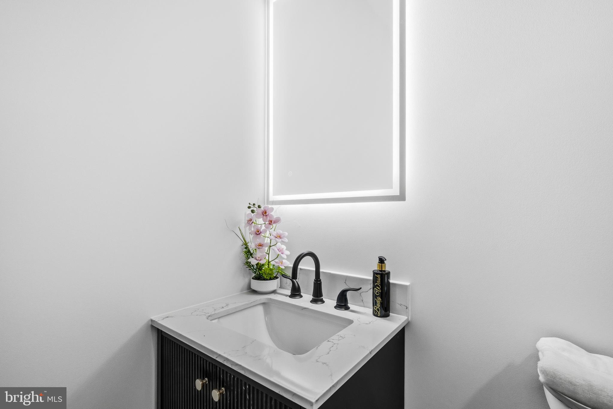 414 Waterford Road Silver Spring, MD 20901 - Photo 33 of 67 a bathroom with a sink and a mirror