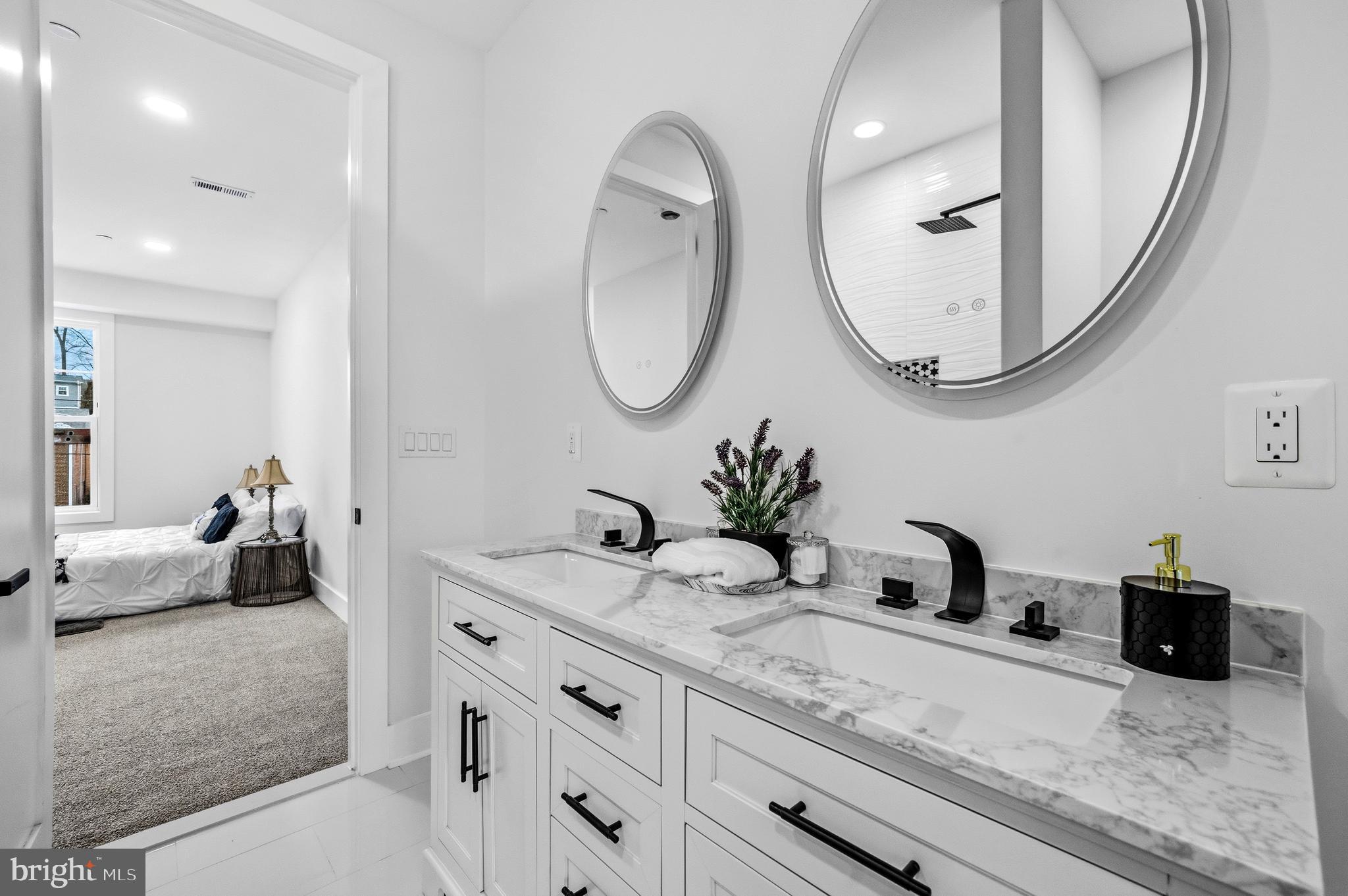 414 Waterford Road Silver Spring, MD 20901 - Photo 38 of 67 a en suite bathroom with a double vanity sink and a mirror