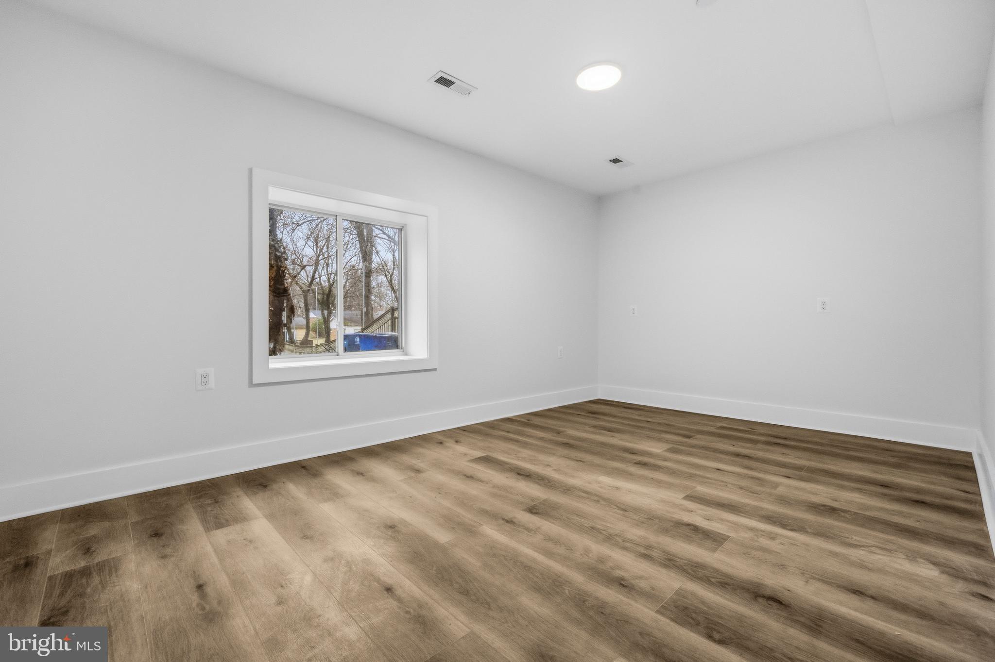 414 Waterford Road Silver Spring, MD 20901 - Photo 51 of 67 wooden floor in an empty room with a window