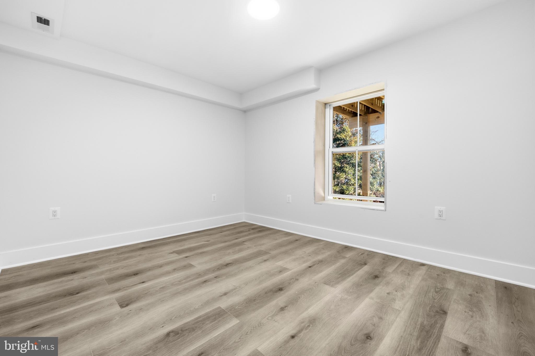 414 Waterford Road Silver Spring, MD 20901 - Photo 53 of 67 an empty room with wooden floor and windows