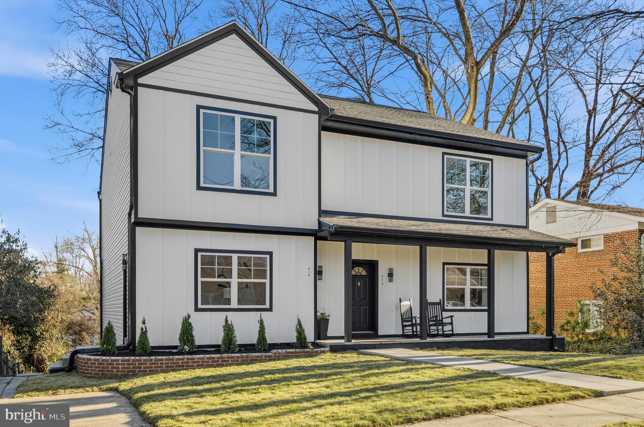 414 Waterford Road Silver Spring, MD 20901 - Photo 60 of 67 a view of a white house with large windows and a table and chairs in a patio