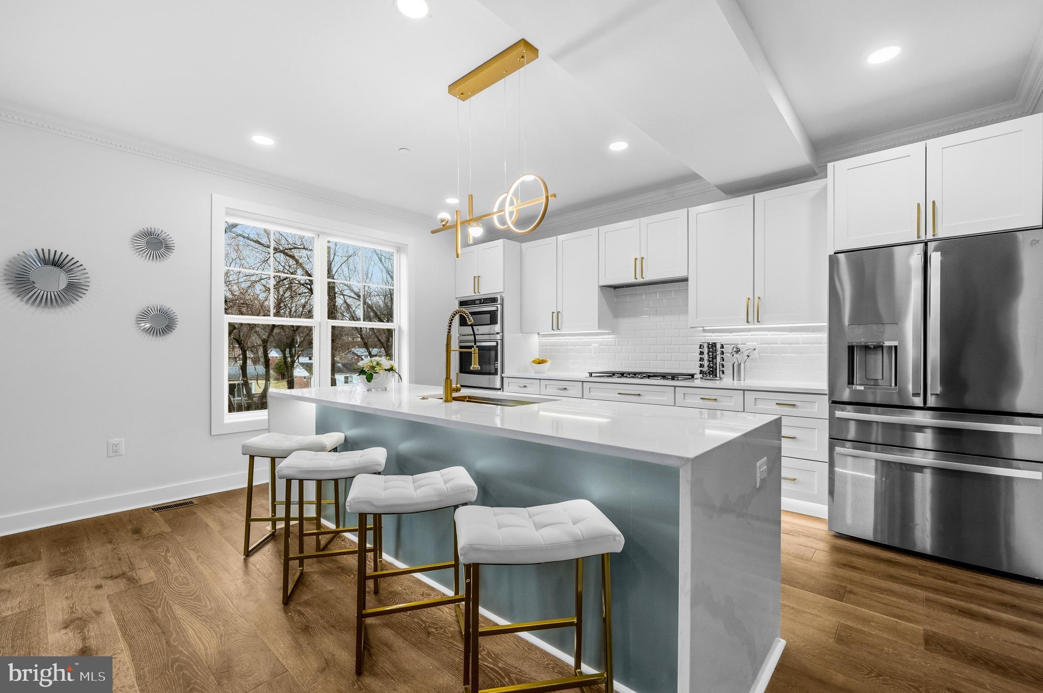 414 Waterford Road Silver Spring, MD 20901 - Photo 7 of 67 a kitchen with stainless steel appliances granite countertop a stove a refrigerator a sink a dining table and chairs with wooden floor