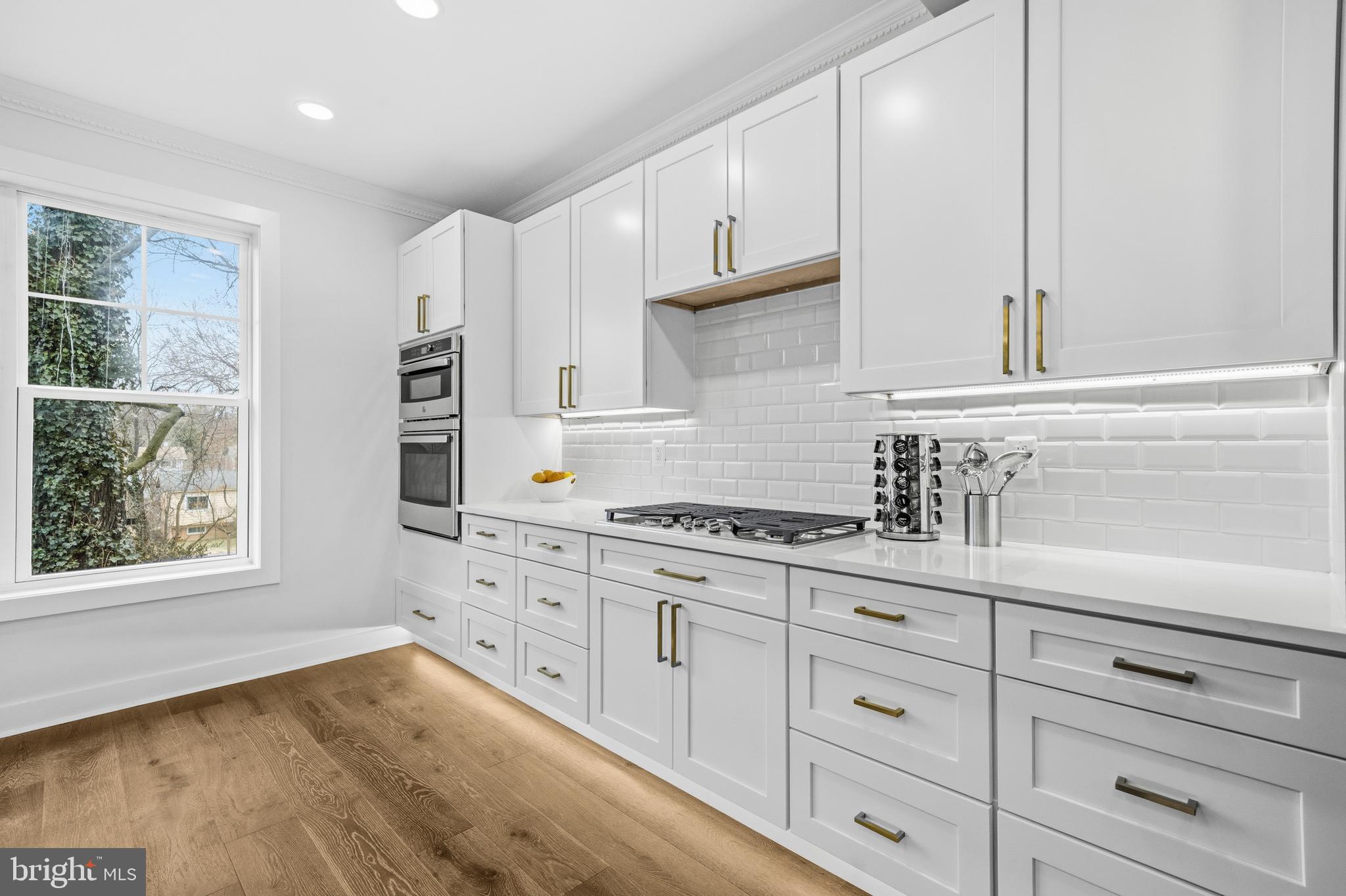414 Waterford Road Silver Spring, MD 20901 - Photo 10 of 67 a kitchen with granite countertop white cabinets and a window