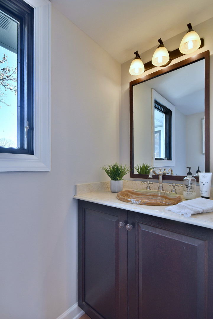 171 North Buckley Road Chicago, IL 60639 - Photo 26 of 42 a bathroom with a sink and a mirror