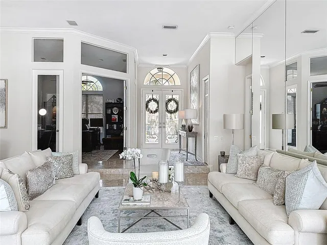 a living room with furniture granite and a chandelier
