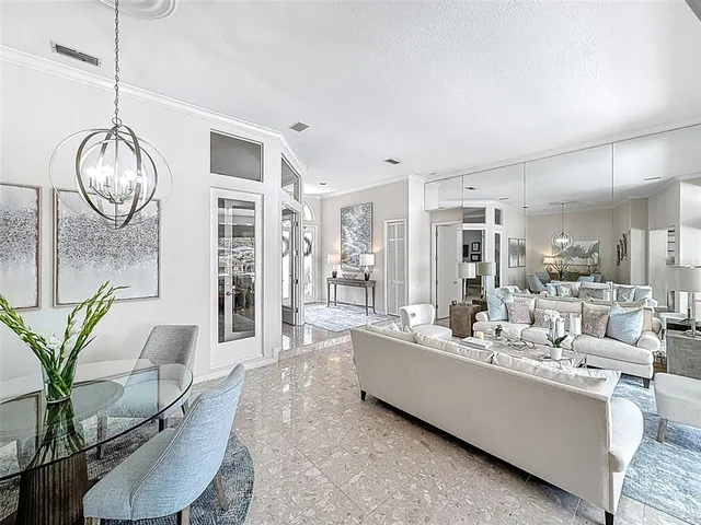 a living room with furniture and a chandelier
