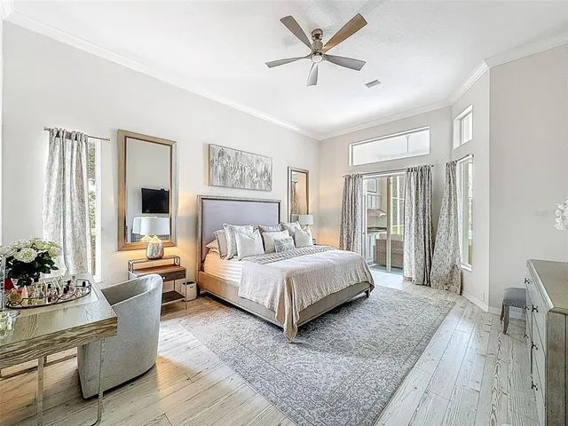 a bedroom with a large bed and a chandelier