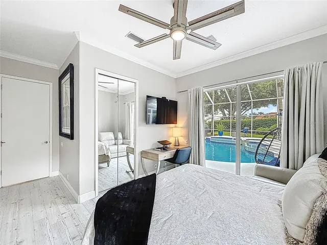 a bedroom with a bed and a large window with the outer view