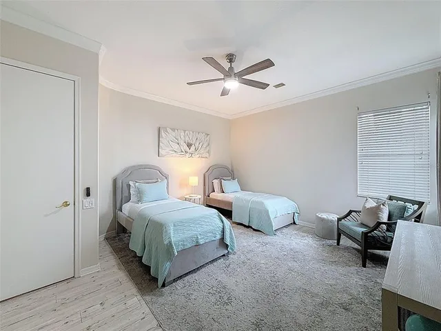 a living room with two bed and a window