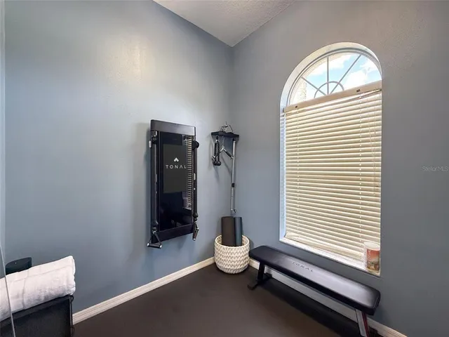a room with a window and ceiling fan