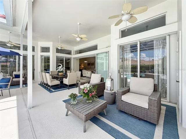 a view of a house with swimming pool and sitting area