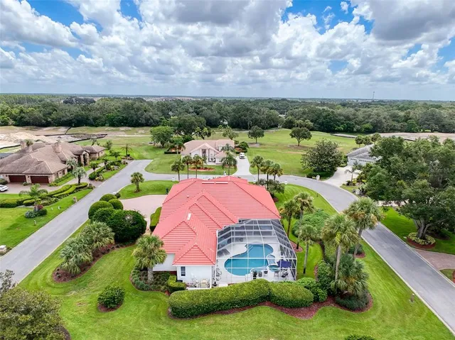 an aerial view of residential houses with outdoor space and garden