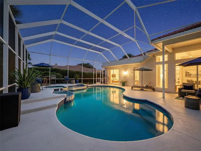 a view of a swimming pool with outdoor seating