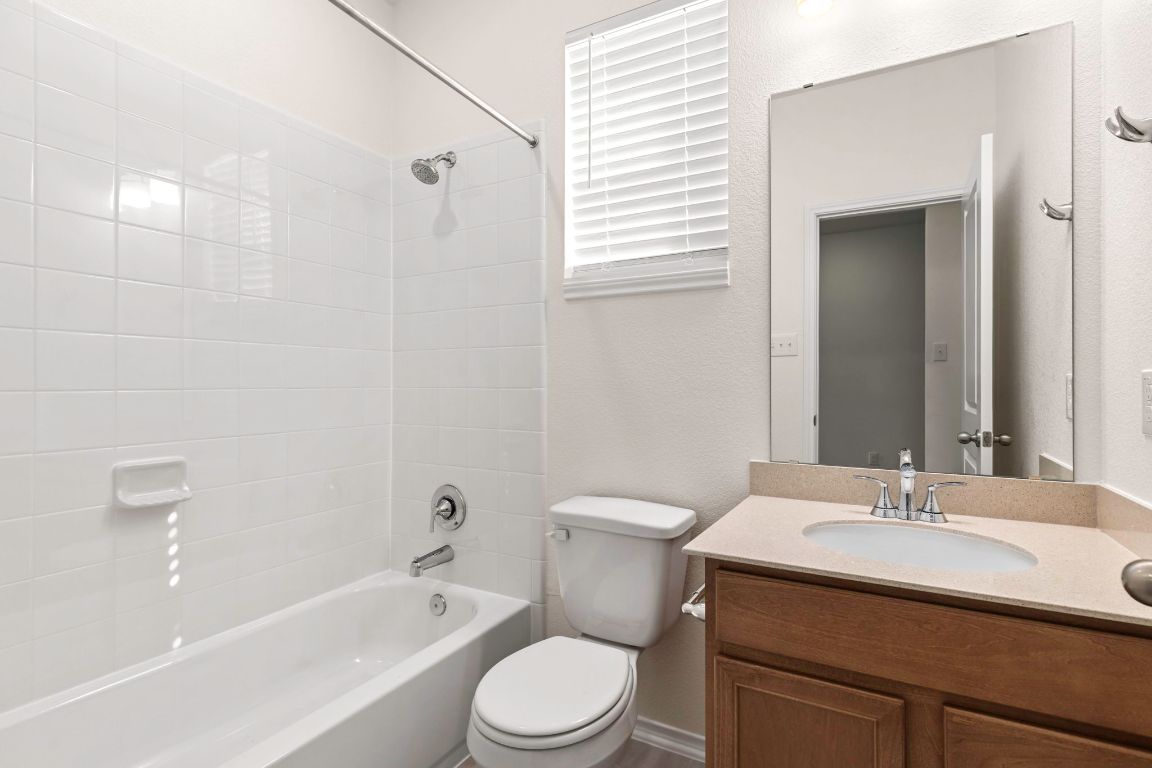 213 Skipping Stone Run Georgetown, TX 78628 - Photo 13 of 31 a bathroom with a sink toilet vanity and bathtub