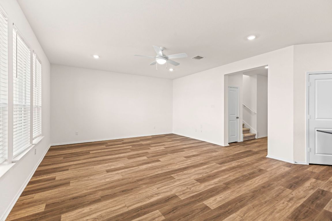213 Skipping Stone Run Georgetown, TX 78628 - Photo 14 of 31 wooden floor in an empty room with a window