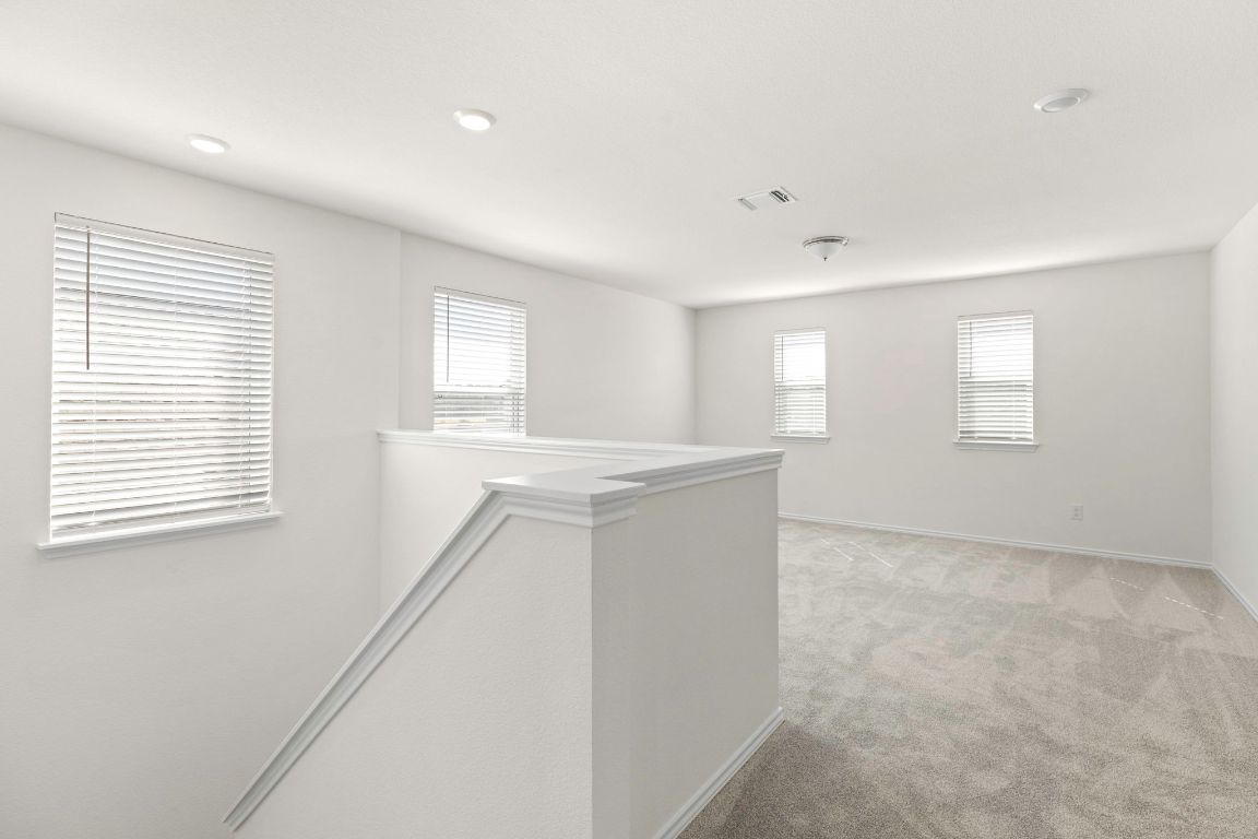 213 Skipping Stone Run Georgetown, TX 78628 - Photo 16 of 31 a view of an empty room with wooden floor and a window