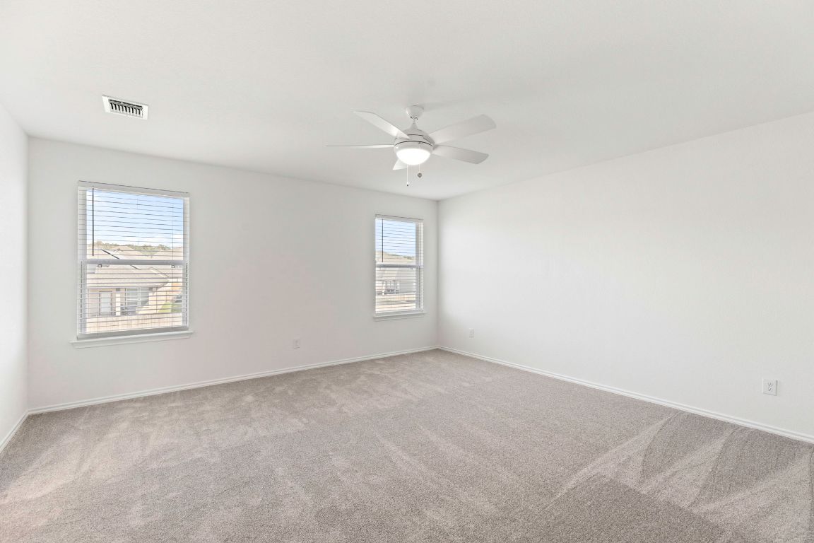 213 Skipping Stone Run Georgetown, TX 78628 - Photo 18 of 31 an empty room with a window and a ceiling fan