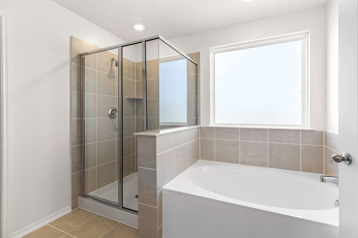 213 Skipping Stone Run Georgetown, TX 78628 - Photo 21 of 31 a bathroom with a bathtub and a shower