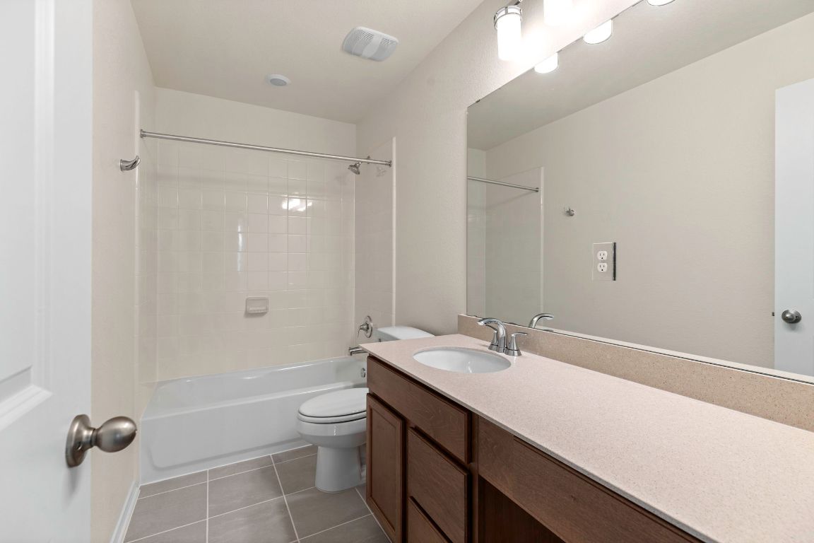 213 Skipping Stone Run Georgetown, TX 78628 - Photo 23 of 31 a bathroom with a sink a toilet and shower