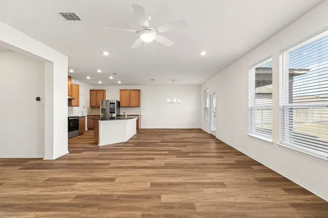 a view of a kitchen with a sink and wooden floor