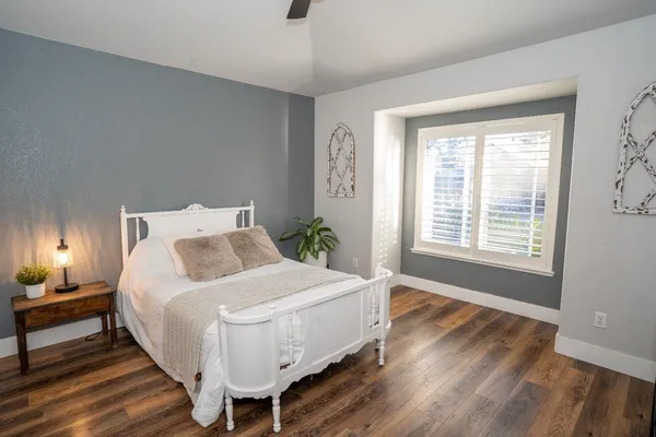 a bedroom with bed and a window