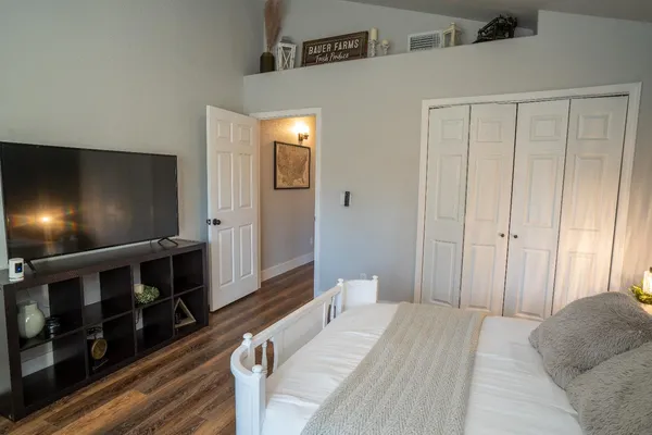a bedroom with a bed and a flat screen tv