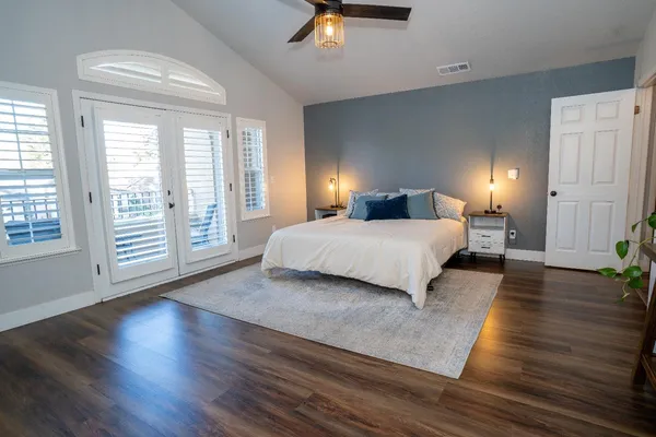 a bedroom with a bed lamps and window