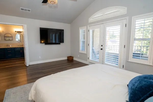 a bedroom with a bed and a flat screen tv