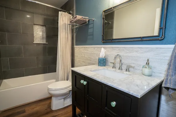 a bathroom with a sink toilet and shower
