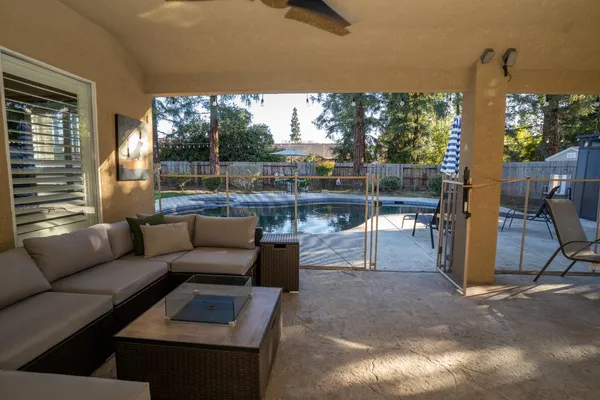 a view of a patio with couches chairs and potted plants