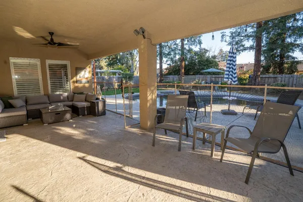 a living room with patio furniture and a potted plants