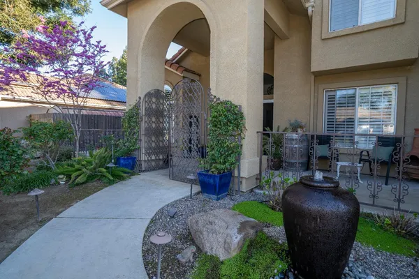 a view of a chair and table in back yard of the house