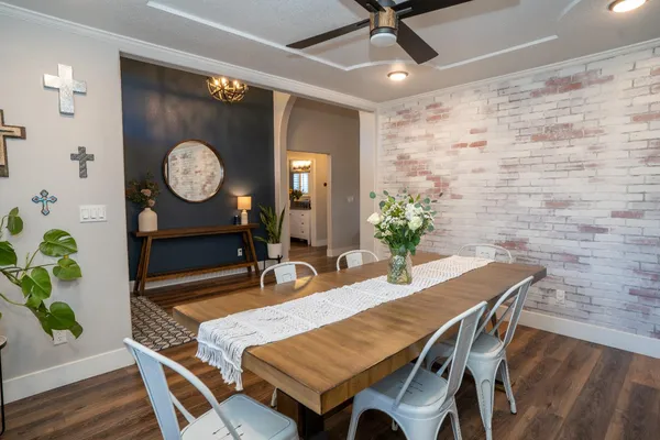 a dining room with a wooden table and a clock
