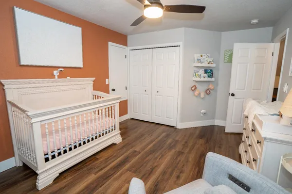 a bedroom with furniture and a wooden floor