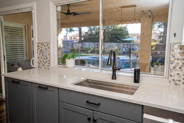 a kitchen with a sink and large window