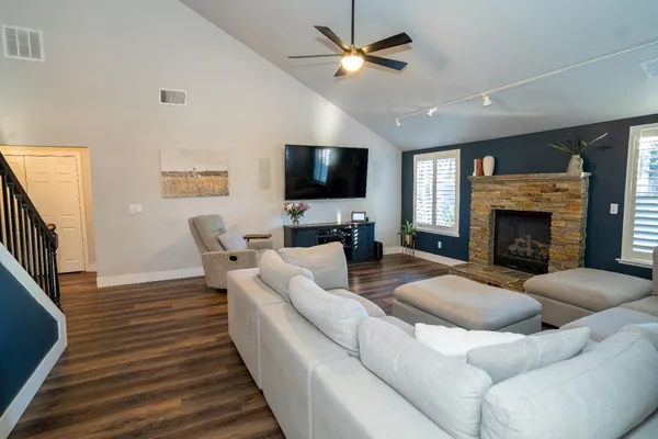 a living room with furniture flat screen tv and a fireplace