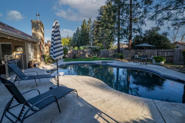 a balcony with table and chairs
