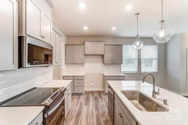 a kitchen with a sink stove and microwave
