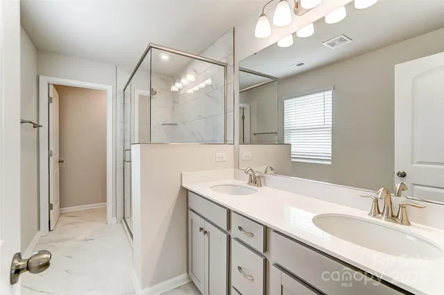 a bathroom with a sink vanity granite and a mirror