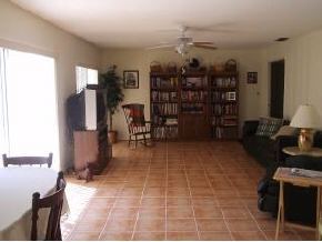 896 Ne Port Palm Bay, FL 32905 - Photo 6 of 9 a room with lots of books and furniture