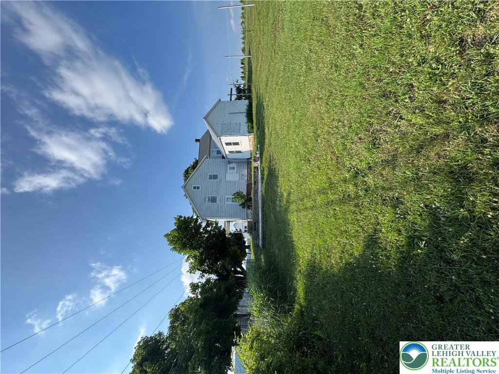 868 Catawissa Road Tamaqua, PA 18252 - Photo 7 of 67 A classic residential structure set against a vibrant green lawn under an open sky.