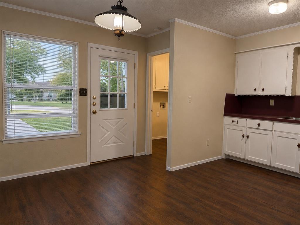 2111 Quail Run, Unit A McKinney, TX 75071 - Photo 5 of 12 an empty room with wooden floor and windows